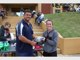 Rising star: Megan Bircher (14) receives her prize from Clive Pieterse after winning the women's 'Banana Bash' triathlon event.