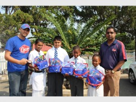 Well-deserved bounty: Coo-ee representatives Steven Clarke (left) and Sundesh Bojraj (right) rewarded Kiara Nepaul, Ashkaar Beharie, Sesam Khusi and Stabile Ngcongo with their hampers for collecting the most caps.