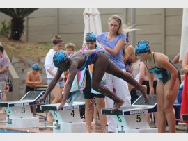 Launch pad: Mbali Burnett (10) of Southbroom dives into the pool in style.