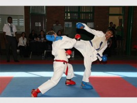 High kick: Diaan Bester (left) and Mahish Panday fighting it out at the champs. Mahish won the U16 championships. 9387SN