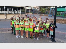 Finishing in style: South Coast Striders' runners and walkers cheer on Freek 'Grondvoel' Stander (back third from left) and Trevor 'Fireman' Burger (black cap) in their 15km challenge last Sunday.
