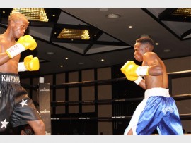 Trading blows: Luyanda Nkwankwa from Cape Town (left) tries to read his opponent Siphamandla Baleni of East London in the most exciting match of the evening, the WBA Pan African Mini Flyweight contest at Wild Coast Sun's 'War on the Shore' boxing tournament held last Friday.