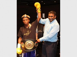 Victorious: Enjoying victory after a very intense tournament, Siphamandla Baleni is congratulated by general manager of the Wild Coast Sun, Myan Moodley, at the 'War on the Shore' boxing tournament held on Friday last week.