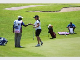 Fist bump: Kim Williams and local caddy Sipho Shusha.