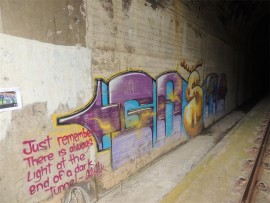 Graffiti by famous artist Gasak decorates one of the railway tunnels alongside the Umzimkhulu River.
