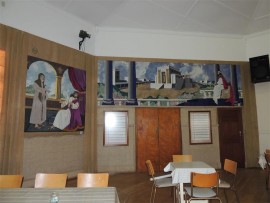 Biblical panels, created by local women, decorate the church hall.