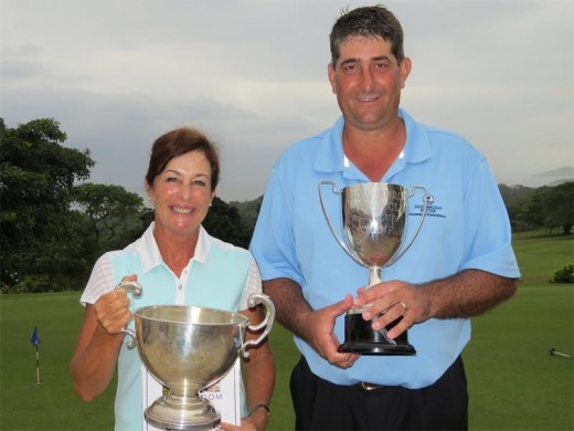 Trophy time: Geraldine Treherne and Gavin Sole share that winning feeling after clinching the strokeplay championships at Southbroom Golf Club last Sunday. PHOTO BY SHEENA JAMES