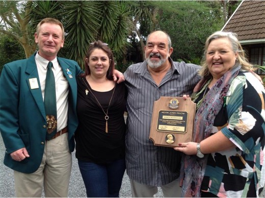 Monica Woodhouse (far right) is congratulated by (from left) Lion Dennis Meyer, Lion Sam Podmore and her husband, Basil Woodhouse.
