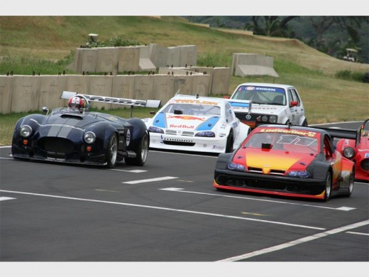 High powered: A number of cars wait at the starting line to begin their race. 3825vee
