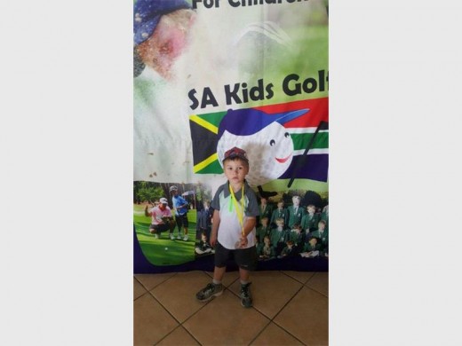 Starting young: Danie van der Spuy shows off his medal.