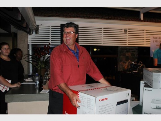 Unexpected: Gavin van Wyk wins the raffle for the day (a printer sponsored by Canon) at the Wozani Berg Gasoline golf day.