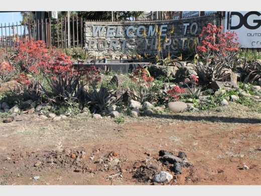 The kerb around the 'Welcome to Port Shepstone' sign has been dug up, making the area look scruffy and untidy.