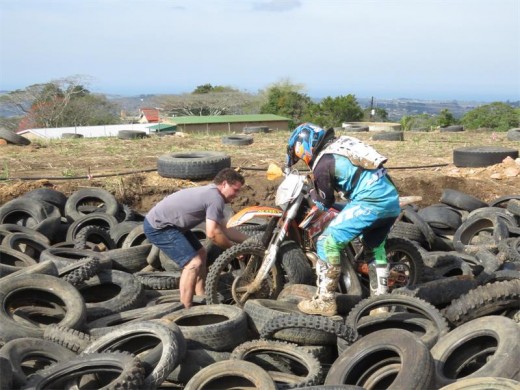 Helpful: Ryan Rossler (left) assists Joshua Sharkey after he got stuck in the tyre pit obstacle. SUBMITTED