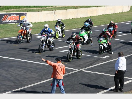 Ready steady: A marshal directs a team of bikers at the starting line. 1682vee