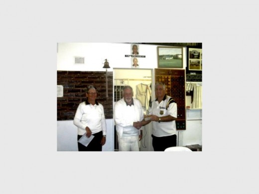 Over up: Jane Massam (left) announces the results of the 'cricket' match between Tweni and Southport. Tweni president Derek Cilliers (middle) hands over the floating trophy to Fanie Strydom, Southport president.