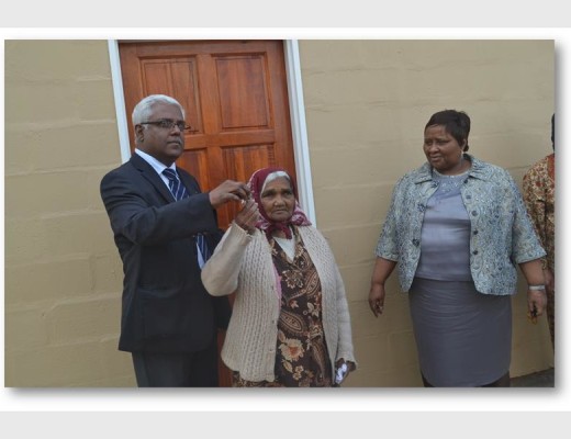 An elderly woman from Marburg recently received a house from Housing MEC Ravi Pillay (left) and Ray Nkonyeni mayor Nomusa Mqwebu Photo: Supplied