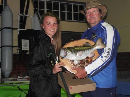 Making her mark: Britney de Bruyn was the winner of the women's biggest bass caught. Club chairman Manus Erasmus presents her with her most impressive trophy.