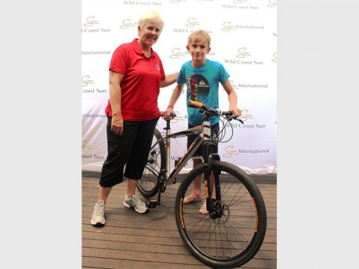 Thank you: Sandi Burger (Wild Coast Sun) congratulates Noah Thomas on winning a bike in the lucky draw.