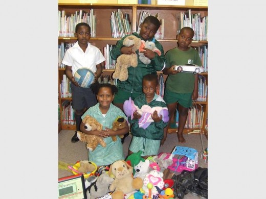 Pupils from Margate Primary (back, from left) Phomello Ntsane, Wandile Mbili, Akhona Lushaba, (front) Amahle Nyuswa and Ntombenhle Nzimande show off the many toys collected for donation.