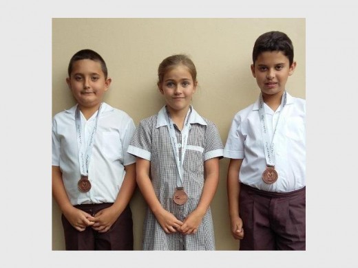 PEPS pupils (from left) Jayden Hall, Freya Scorer, Matthew Michau all received medals for their efforts at the 500m open water swim at Lake Eland recently.