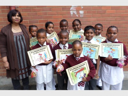 RA Engar foundation phase head of department Seetha Sukai (left) congratulates reading festival entrants (back, from left) Zama Majombozi, Teashka Soorijlah, Simo Bongwa, Leocardia Reddy, Azanda Dube, (front) Yonela Gumede, Khanya Njomi, Uzai Maharaj, Nomonde Zulu and Kuhlekonke Hlatshwayo who received sweet hampers, certificates and a book.