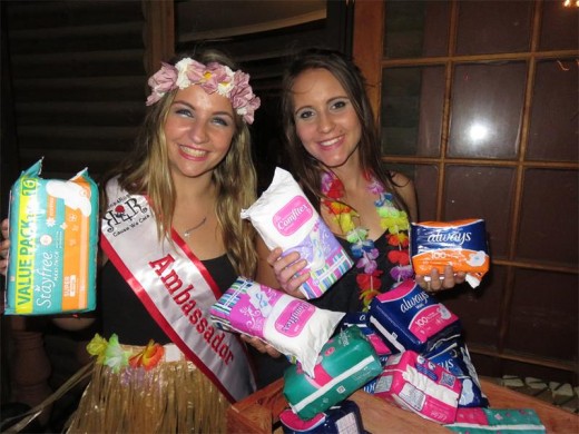 Waitresses, Tarryn Schlehmeyer (left) and Jayde Horne with the many packs of sanitary pads that were donated.