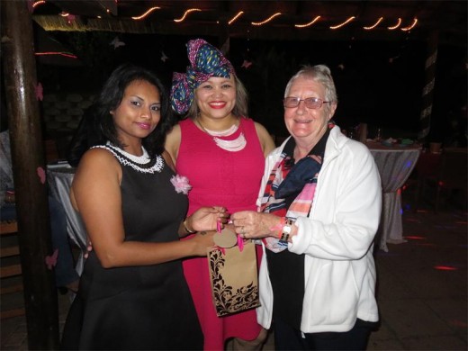 Malani Padayachee (left) and Revanea Coetzee (middle) of  the Events Circle, hand over proceeds from the event to Jeanie West of the CANSA Association.