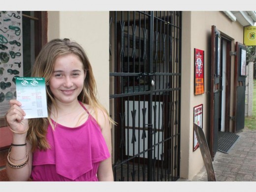 Cassidy Massey with the Pumula Crime Watch's 'numbers to know' flyer.
