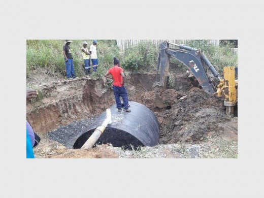 Ugu municipality staff install a temporary sewerage system in Masinege on Wednesday this week. Photo: Ugu