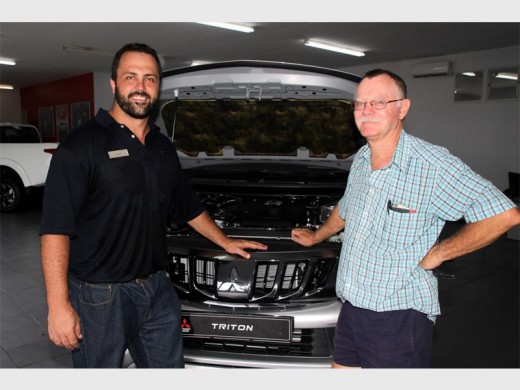 Sleek: Mitsubishi sales executive Ignus Verter (left)) shows Charles le Roux of Southport the powerful engine. 0176vee