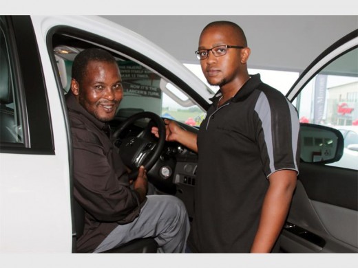 Driver's seat: Mitsubishi sales executive Ntsiki Majola (right) helps Agrippa Mbewana of Izingolweni with a test drive. 0179vee