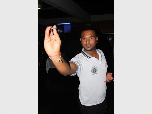 Missile thrower: Denzil Naidoo of Jumperz Darts Club takes aim for the bullseye during the competition. 9324SN