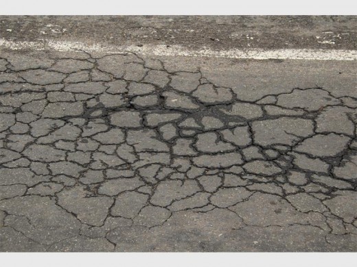 More cracks on the stretch of road where the contractor was working.