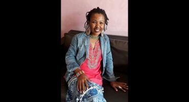Ayanda Ndaba seated on a couch.