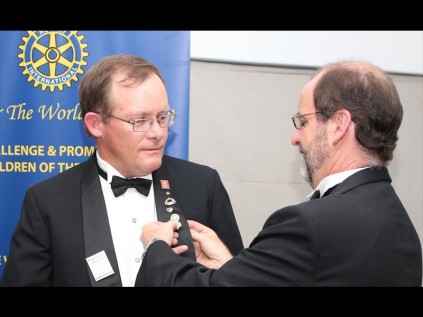 Andrew Killick has his Paul Harris badge pinned on by Phillip Walsh
