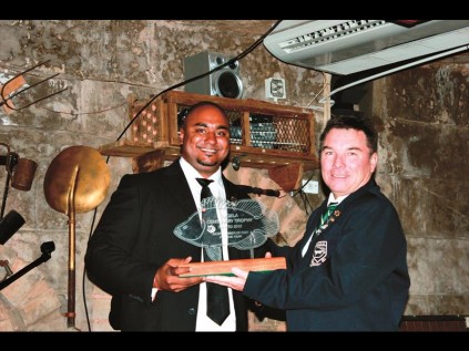 Champion Angler of the Year, Rowen Moodley, accepts his trophy from Barry Tedder