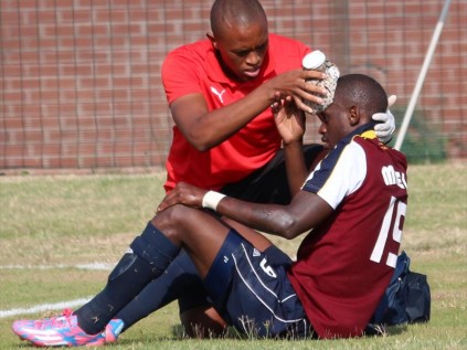 Innocent Maela gets some treatment from physio Sthembiso Masondo after being brutally elbowed in the face