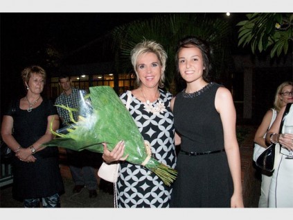 PHOTOS: ISABELLA VAN SCHALKWYK Flowers for the lady Interior decorator and local busines woman, Isabella van Schalkwyk, is presented with flowers by Grade 12 representative Melissa Gloy