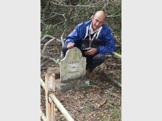 Ezemvelo KZN Wildlife Honorary Officer, Paul Gouge next to the forlorn gravestone with its terse, melancholy message