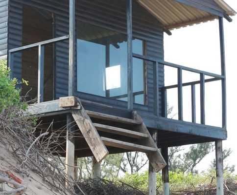 High water erosion of the dune barrier at Newark Beach has damaged the lifeguard tower steps, with sea water at times spilling over onto the grass area behind