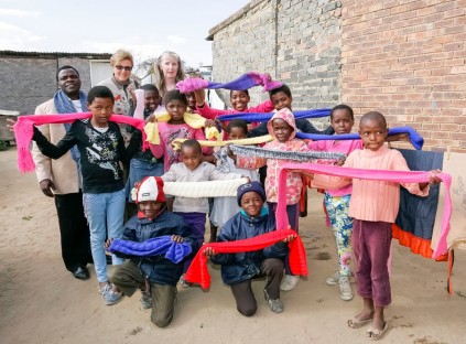 The children show off their scarves.
