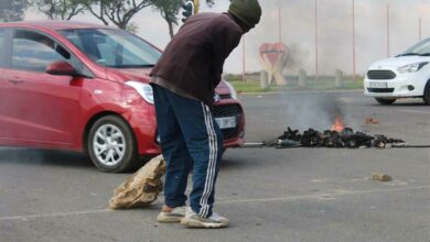 Resident Bonga Mthembu clears the road