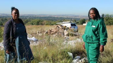 [BEFORE] Building rubble behind Ward 110 councillor Angie Mphaho and Annikie Mothibi, social development ward committee member. Photo: Sphiwe Masilela