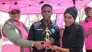 Mimi Mokoena from Vuma congratulates top goal scorer Gugulethu Nkosi with MLFA assistant secretary Makarina Mokoena. Photo: Sphiwe Masilela