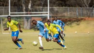 Indlovu FC player Xolani Skosana sprints with the ball as Sundowns players chase him.
