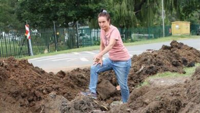 Glen Austin resident Lesley Allanby points at the damaged pipe. Photo: Sphiwe Masilela