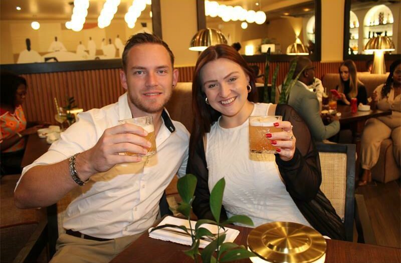 Ross Wilkinson and Janelle Jamse van Rensburg enjoy drinks. Photo: Sphiwe Masilela