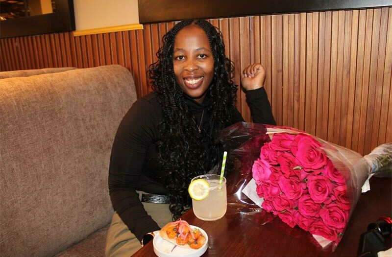 Nozipho Ndlela with a drink and a bouquet of flowers. Photo: Sphiwe Masilela