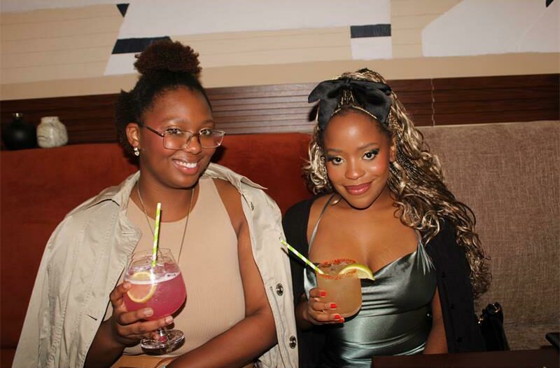 Ntombi Khulu and her friend Shamiso Muvavarirwa sips on drinks. Photo: Sphiwe Masilela