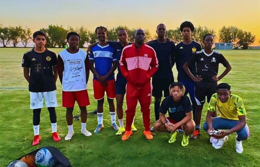 Rush Hour Sports Management director and soccer agent Rush Ratshibvumo Mulovhedi (red) is flanked by players.